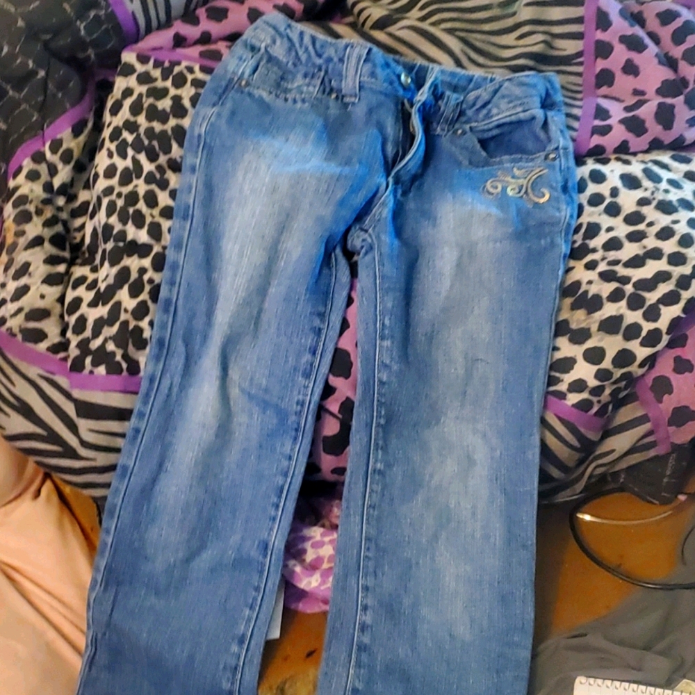 Blue jeans 👖with silver trim around the pockets